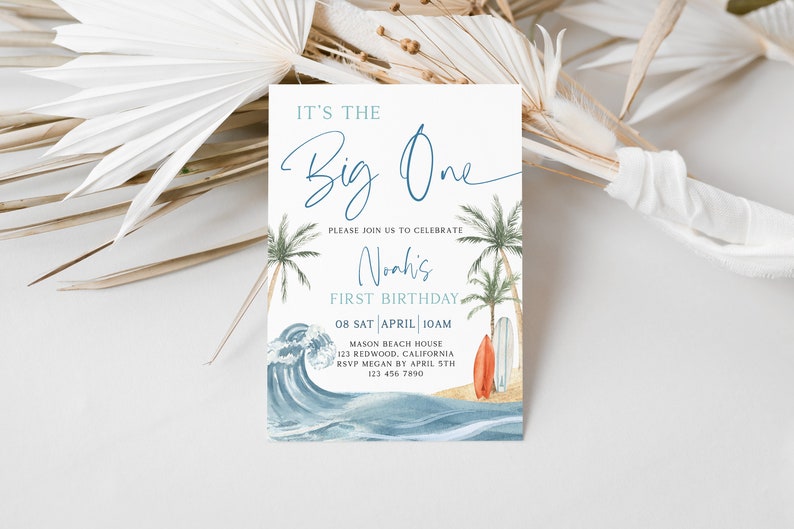 May include: A blue and white invitation card with a beach theme. It says "It's the Big One" and "Noah's First Birthday". The date and time of the party are listed as "08 SAT APRIL 10AM". The location is "MASON BEACH HOUSE 123 REDWOOD, CALIFORNIA". The RSVP information is "RSVP MEGAN BY APRIL 5TH 123 456 7890".
