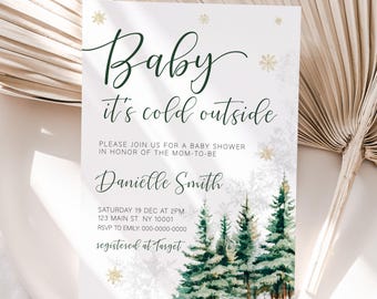 Op de afbeelding: Een witte babyborrel uitnodiging met een winters boslandschap. De tekst luidt "Baby it's cold outside" en bevat details over het evenement, inclusief de datum, tijd, locatie en RSVP-informatie. De uitnodiging vermeldt ook dat de gast van eer geregistreerd is bij Target.