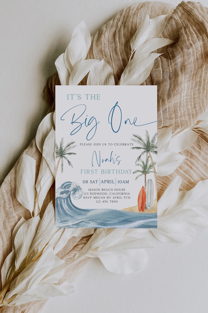 May include: A blue and white invitation card with a watercolor illustration of a beach scene. The text reads "It's the Big One" and "Please join us to celebrate Noah's First Birthday". The date, time, and location are also included.
