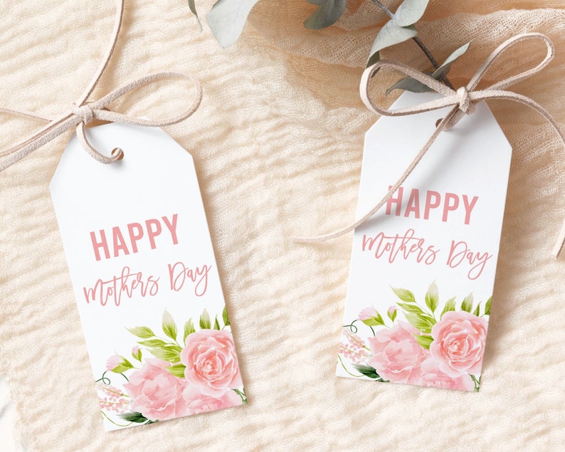 May include: Two white gift tags with pink floral designs and the text "Happy Mothers Day" in pink lettering.
