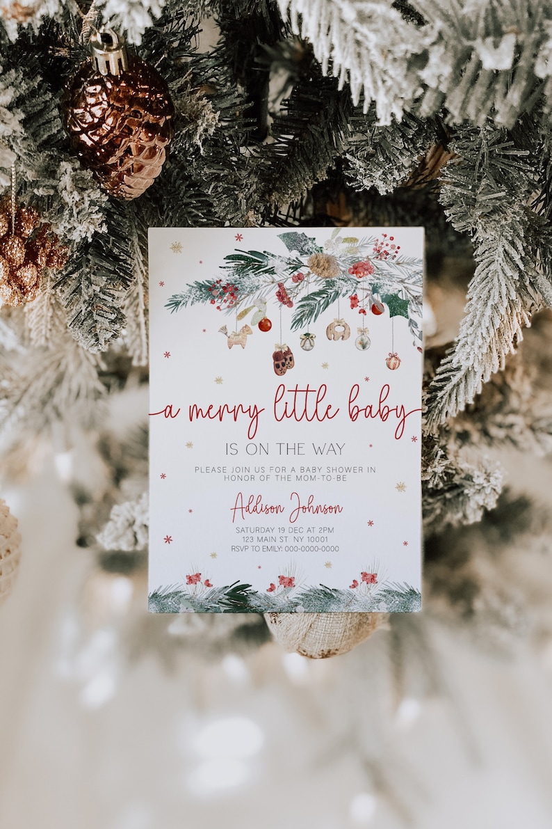 May include: A white baby shower invitation with a wintery design featuring a green pine branch with red berries and ornaments. The text reads "a merry little baby is on the way" and includes the name "Aldison Johnson", the date and time of the shower, and the address.