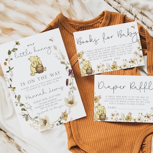 May include: A Winnie the Pooh themed baby shower invitation with floral accents. The invitation reads "our little hunny is on the way" and includes the date, time, and location of the shower. There are also two cards for guests to write messages for the baby, one for books and one for diapers.