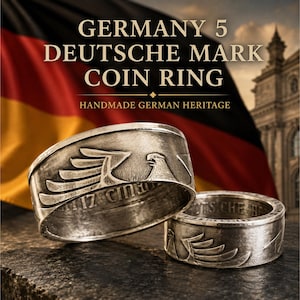 May include: Two silver-toned metal rings crafted from Germany 5 Deutsche Mark coins, featuring an embossed eagle design on the outer band and visible lettering along the inner rim, displayed against a background with the text GERMANY 5 DEUTSCHE MARK COIN RING.