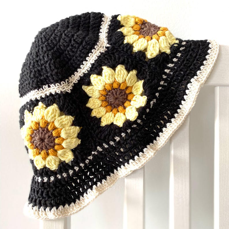 Black crochet sunflower bucket hat with cream edging and sunflowers around crown of hat.