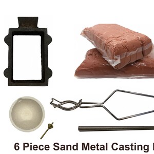 May include: A 6-piece sand metal casting kit. The kit includes a black metal mold, two packages of reddish-brown sand, a crucible, a small brass tool, a pair of tongs, and a metal rod. The text "6 Piece Sand Metal Casting Kit" is at the bottom.