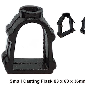 May include: A black casting flask with a rectangular base and arched opening. The flask is 3.27 inches tall, 2.36 inches wide, and 1.42 inches deep. The text "BLACK BARN DESIGN" is printed vertically on the left side of the image.