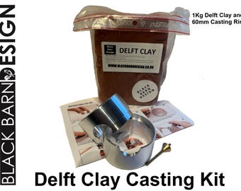 May include: A Delft Clay casting kit featuring a 1kg bag of brown clay labeled Black Barn Design, a 60mm metal casting ring, and instructional cards. The kit includes a small metal tool and is presented in a clear plastic bag with text.