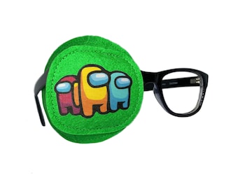 May include: Green eye patch with a printed image of four Among Us characters. The eye patch is attached to a pair of black framed glasses.