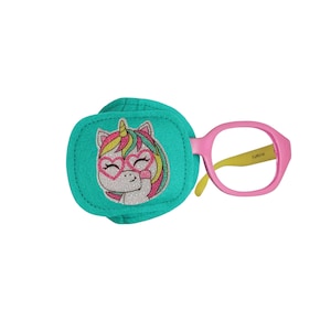 May include: A turquoise eye patch featuring a glittery unicorn wearing heart-shaped sunglasses. The patch is attached to a pink plastic frame with yellow arms.