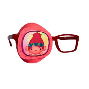 May include: Pink eye patch with a cartoon troll girl with red hair and a flower crown. The eye patch is attached to red plastic glasses.