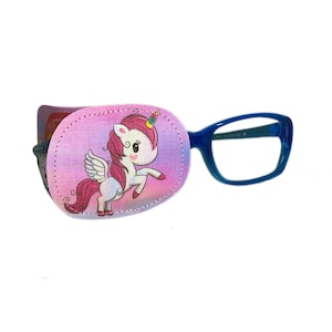 May include: A pink and purple eye patch with a unicorn design. The patch is attached to a pair of blue framed glasses.