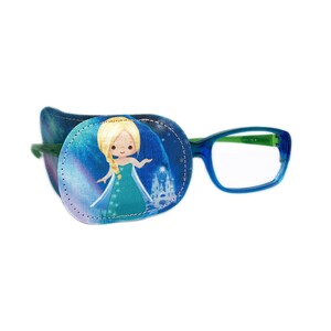 May include: A blue and green eye patch with a cartoon image of a princess in a blue and green dress. The eye patch is attached to a pair of blue framed glasses with green arms.