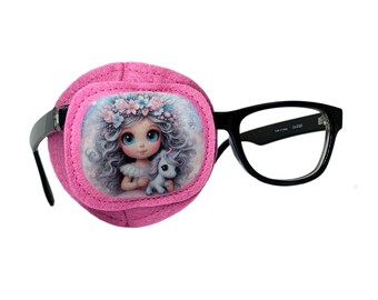 May include: Pink eye patch with a felt backing and a printed image of a girl with a unicorn. The patch is attached to a pair of black framed glasses.