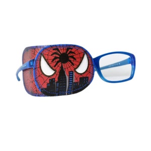 May include: A red and blue eye patch featuring a Spiderman design. The patch has a spider web pattern with a black spider and a cityscape in the background. The eye patch is attached to a pair of blue plastic glasses.