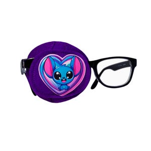 May include: Purple eye patch with a heart-shaped design featuring a cartoon blue character with pink ears and big eyes. The eye patch is attached to a pair of black framed glasses.