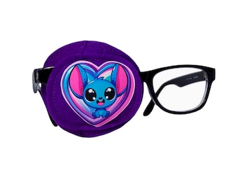 May include: Purple eye patch with a heart-shaped design featuring a cartoon blue character with pink ears and big eyes. The eye patch is attached to a pair of black framed glasses.