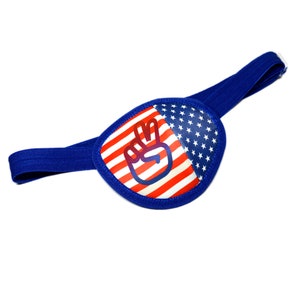 May include: A blue eye patch with an American flag design and a peace sign in the centre.