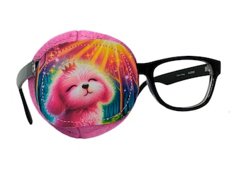 May include: Pink eye patch with a colorful illustration of a dog wearing a crown. The eye patch is attached to a pair of black framed glasses.