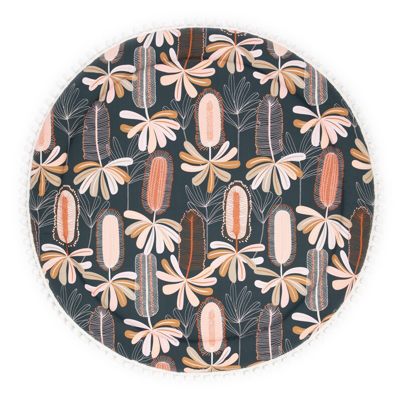 May include: A round, dark green play mat with a white pom-pom trim. The mat features a repeating pattern of stylized pink and orange flowers.