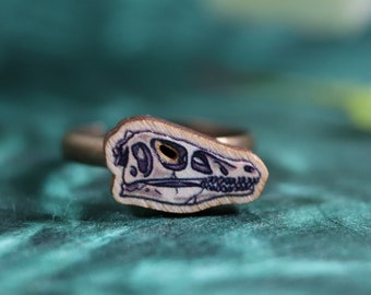 Ring with wooden Velociraptor skull charm