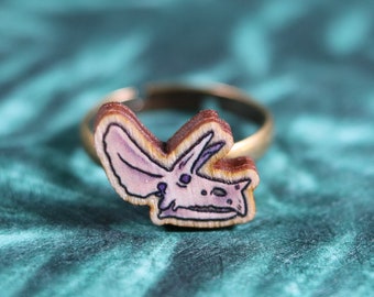 Ring with wooden Triceratops skull charm