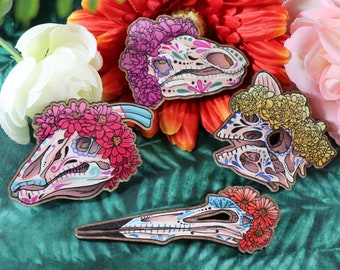 Díno de los Muertos Skulls Part 2 – Dinosaur Pins & Magnets