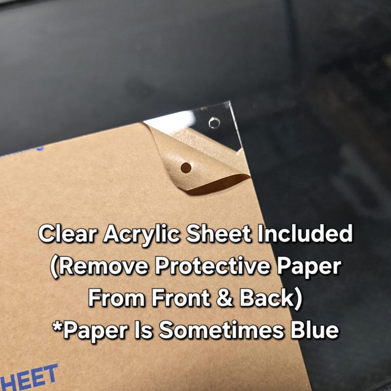 May include: A clear acrylic sheet with protective paper partially peeled back, revealing a corner with pre-drilled holes. Text on the image reads "Clear Acrylic Sheet Included" and "Remove Protective Paper From Front & Back".