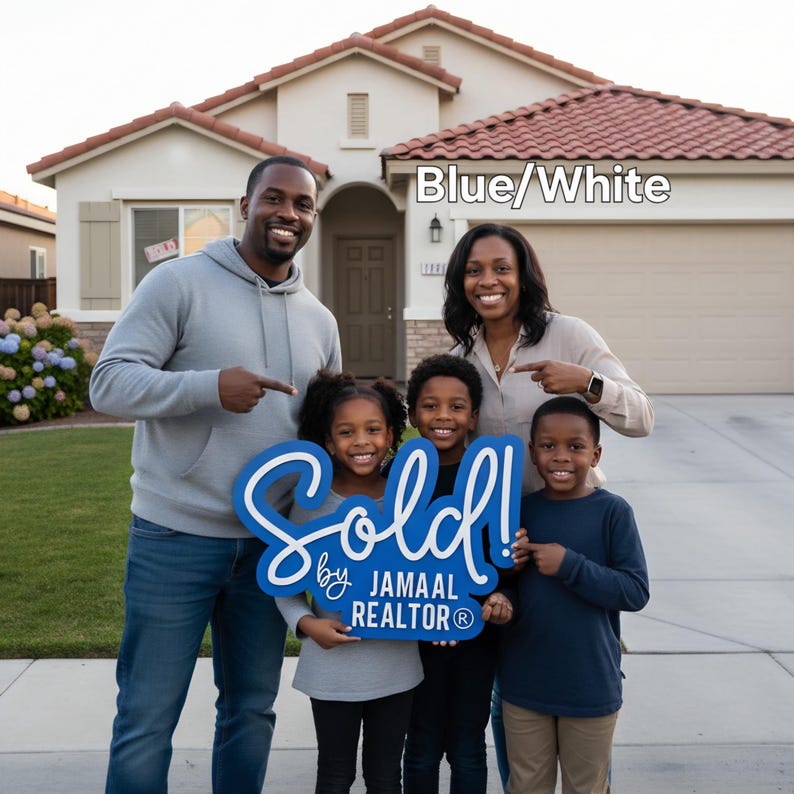 May include: A family stands in front of a house, holding a blue and white sign that says "Sold!" with "by Jamaal Realtor&reg;" below. The house has a red tile roof and a beige exterior. The sky is clear and the day is sunny.