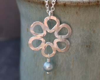 Handmade hammered silver daisy pendant with freshwater pearl on silver trace chain. Flower necklace. June birthstone