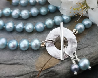Handmade contemporary duck egg blue freshwater pearl necklace with hammered silver circle toggle fastening. June birthstone