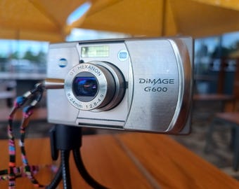 Konica Minolta DiMAGE G600 6MP CCD Digital Camera Tested Working Metal Compact Y2K Charger Battery SD Card
