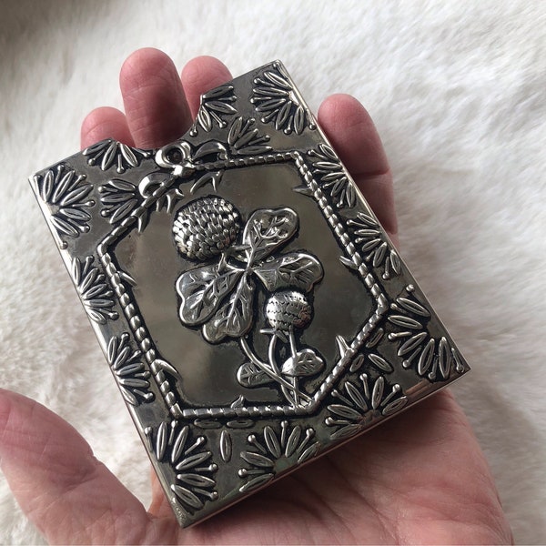silver card case with lucky clover