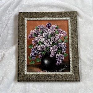 May include: A white ceramic mug with a black handle and the text "But First, Coffee" in a bold, black font. The mug is sitting on a wooden surface. The mug is approximately 4 inches tall.