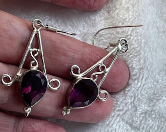 Silver dangle earrings with faceted purple accent