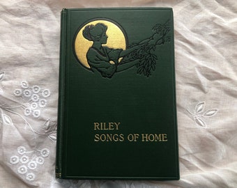 May include: A green hardcover book with gold lettering that reads "Riley Songs of Home". The cover features a gold silhouette of a woman reaching towards a tree branch.