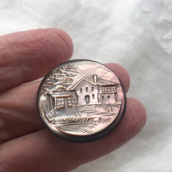Carved pearl button with house scene