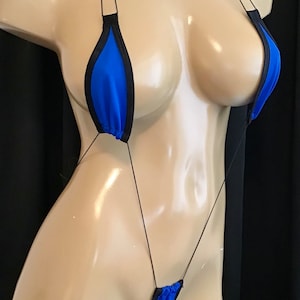 May include: A blue and black micro bikini with thin straps. The bikini is made of a stretchy fabric and has a small triangle top and a thong bottom.