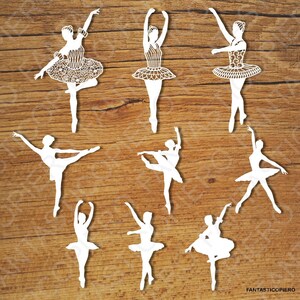 May include: A collection of nine white paper die-cut silhouettes of ballet dancers in various poses. Each figure features intricate lace-like cutouts on the tutus and bodices. The text FANTASTICOPIERO is printed in the bottom right corner.