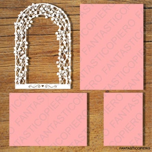 May include: A white paper cut-out of a wedding arch with a vine and leaf design. The arch is on a pink background.