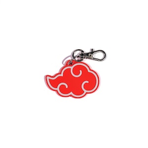 May include: A red cloud-shaped keychain with a white outline and a silver clasp. The keychain is a vibrant red color and features a stylized cloud design. The clasp is made of shiny silver metal.