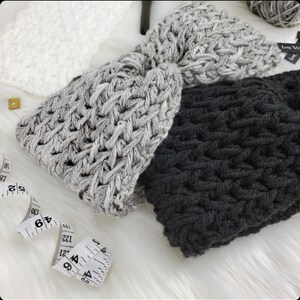 May include: Three crocheted headbands in gray, black, and white. The headbands are made with a chunky yarn and have a simple, textured design.