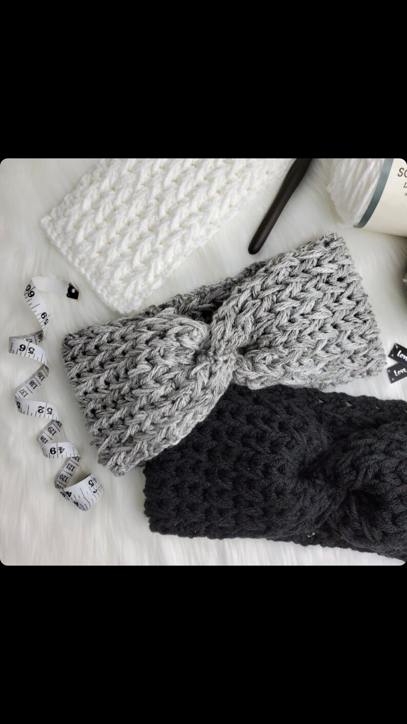 May include: Three crocheted headbands in white, gray, and black. The headbands are made with a chunky yarn and have a twisted knot design.