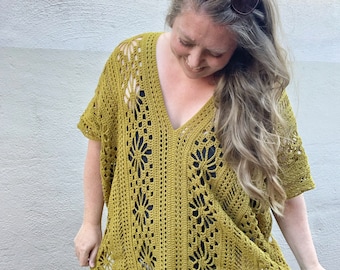 May include: A mustard yellow crochet cover-up with a V-neck and a floral pattern.