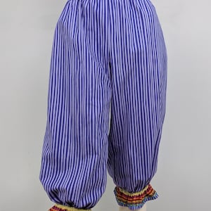 May include: Purple and white striped pants with a gathered elastic waistband and colorful trim around the cuffs.
