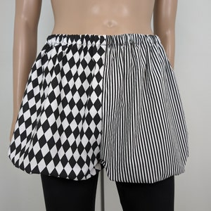 May include: Black and white checkered and striped shorts with a gathered elastic waistband.