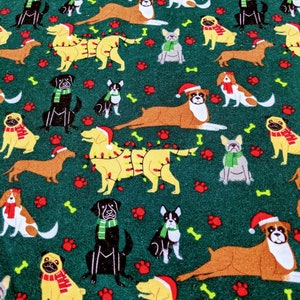 May include: A festive fabric pattern featuring various dog breeds in holiday attire. The dogs are adorned with Santa hats, scarves, and some are decorated with Christmas lights. The background is a dark green with paw prints and bone accents.