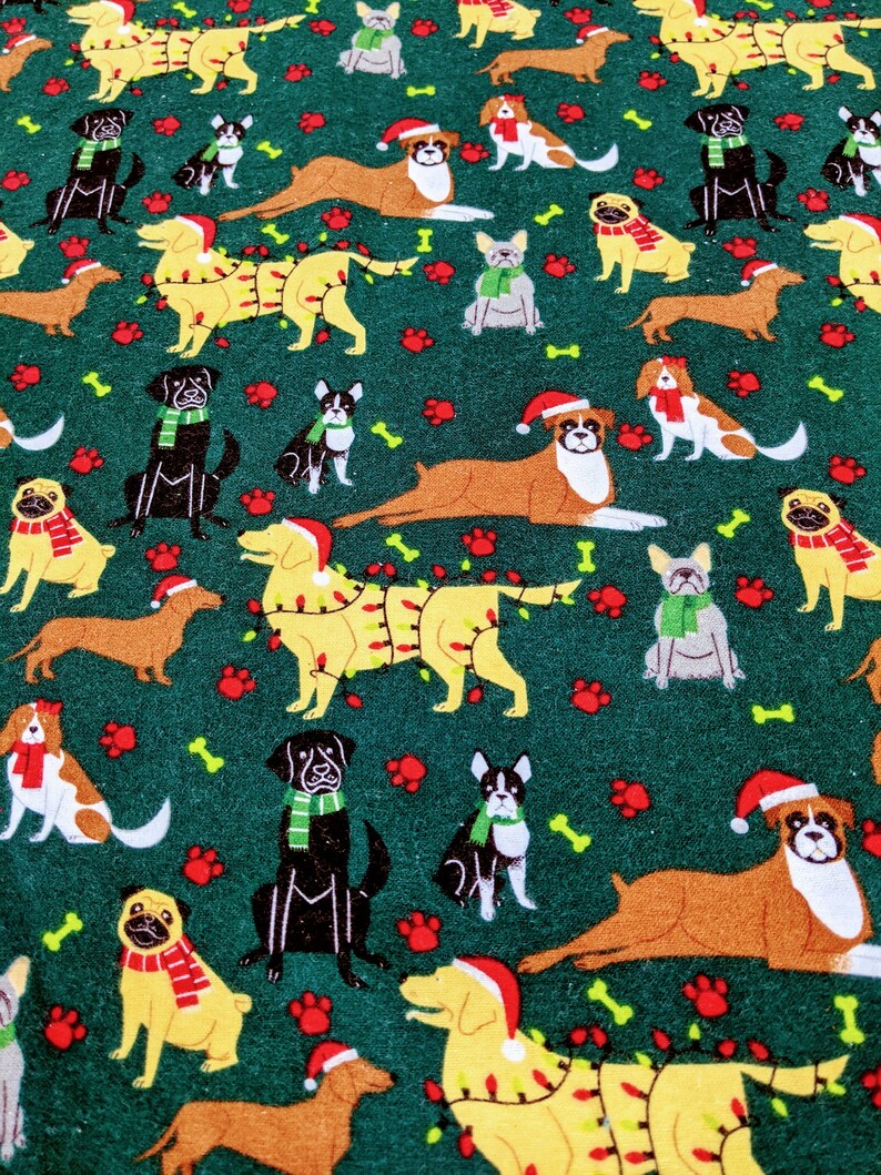 May include: A festive fabric pattern featuring various dog breeds in holiday attire. The dogs are adorned with Santa hats, scarves, and some are decorated with Christmas lights. The background is a dark green with paw prints and bone accents.