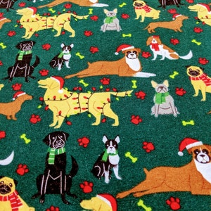 May include: A green fabric featuring a repeating pattern of various dog breeds. Some dogs wear Santa hats, scarves, or are decorated with Christmas lights. The design includes paw prints and bones, creating a festive holiday theme.