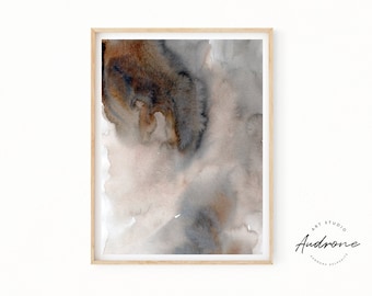May include: Abstract watercolor painting in shades of brown, gray, and white. The painting is framed in a light wood frame.
