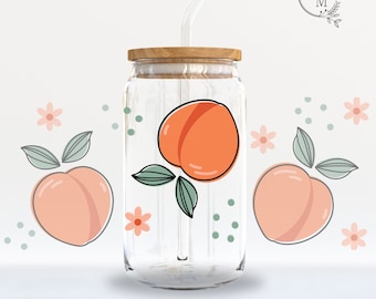 May include: A 16oz glass can wrap with a peach design. The wrap features two peaches with leaves and a green and white polka dot pattern. The text "16oz CAN GLASS WRAP" and "SVG | PNG | DXF | EPS" is printed below the image.